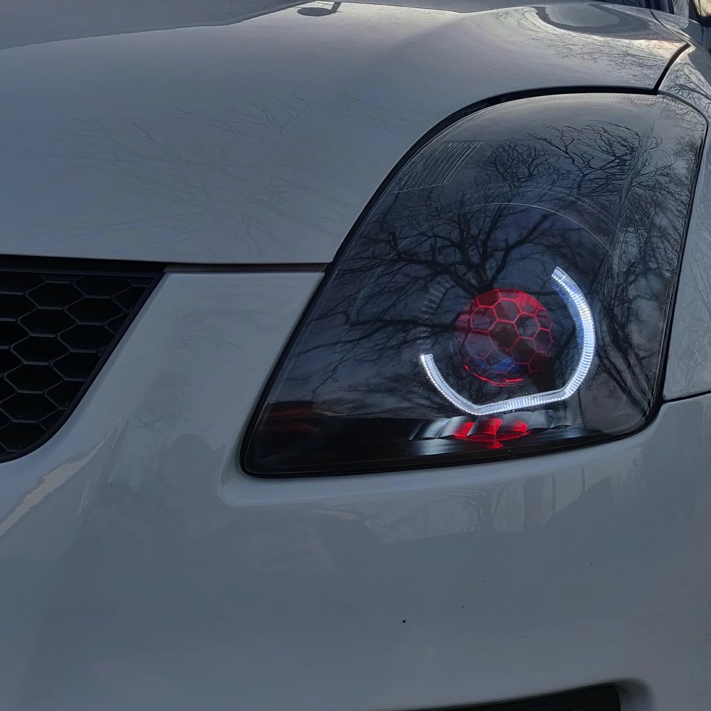 Front shot Suzuki Swift red headlights